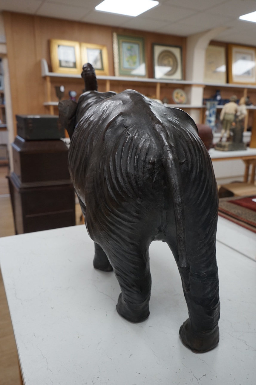 A large Liberty style leather elephant, 64cm wide. Condition - fair, minor repairs